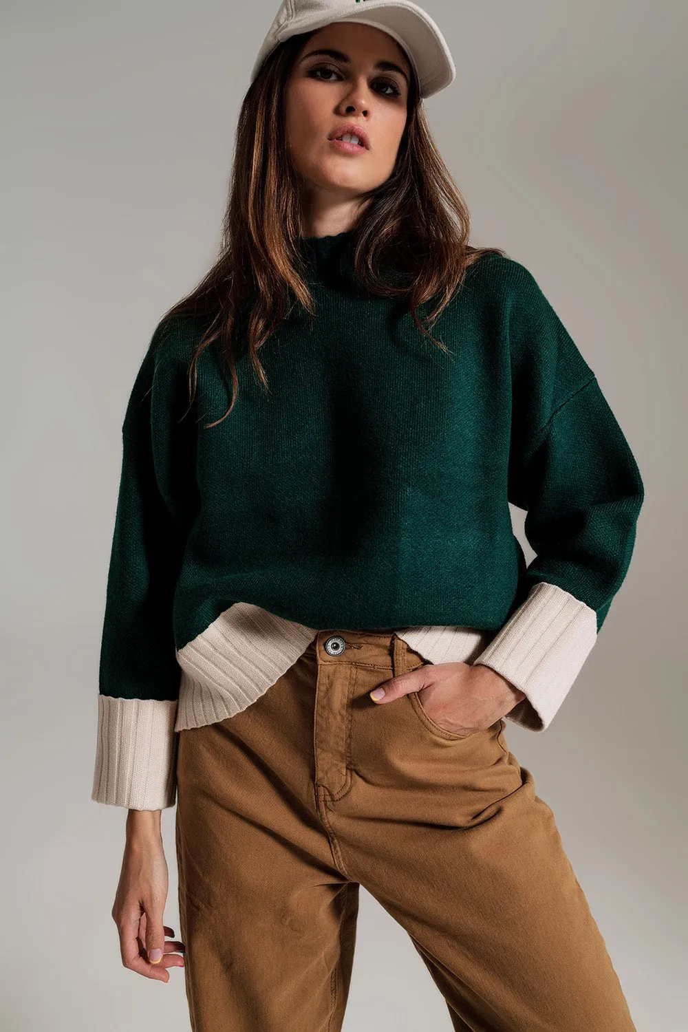 green jumper with white ribbed cuffs and hem